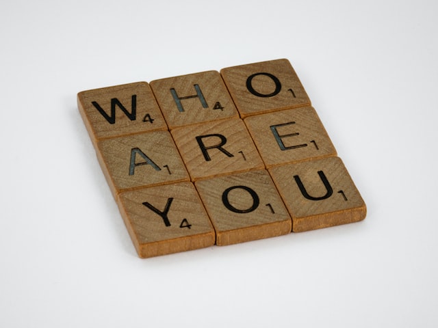 Scrabble pieces forming the words 'Who are you?'