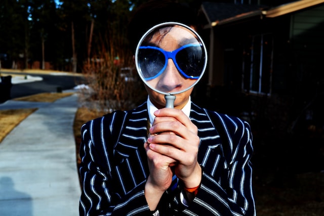 Man with a magnifying glass in front of his face